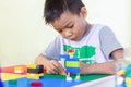 AsianÃ¢â¬â¹ childÃ¢â¬â¹ boyÃ¢â¬â¹ playingÃ¢â¬â¹ withÃ¢â¬â¹ theÃ¢â¬â¹ plasticÃ¢â¬â¹ blockÃ¢â¬â¹ toys.Ã¢â¬â¹